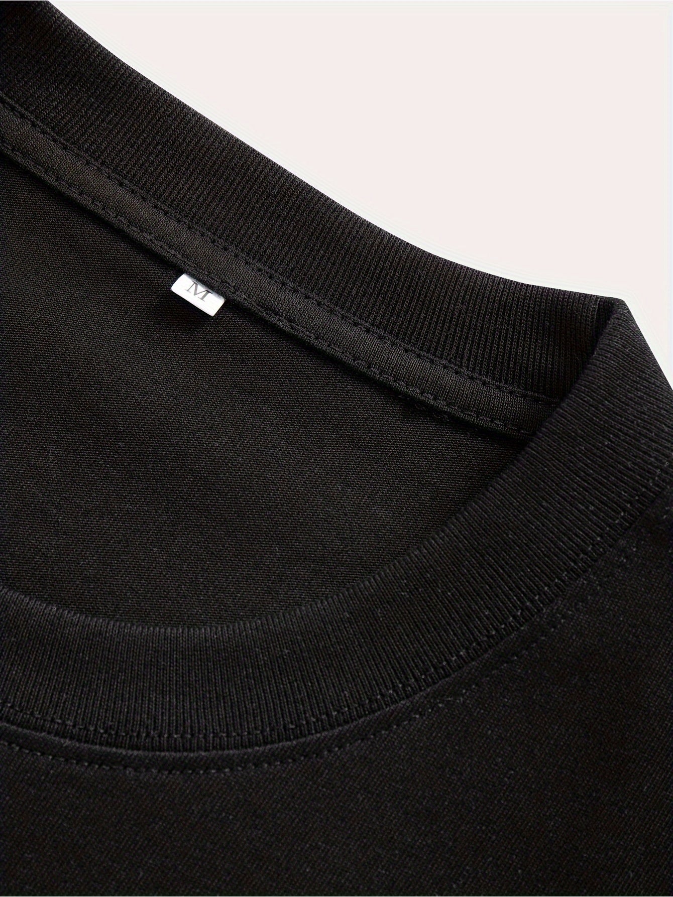 Close-up of black fabric neckline detail of American printed summer t-shirt by LUNIVA CARE USA