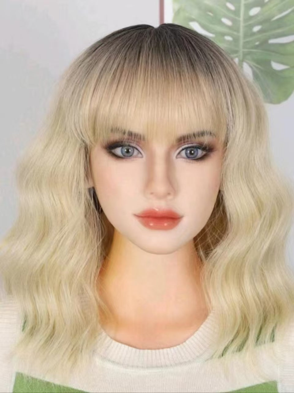 LUNIVA CARE USA short wavy synthetic wig with bangs in blonde ombre style on mannequin head