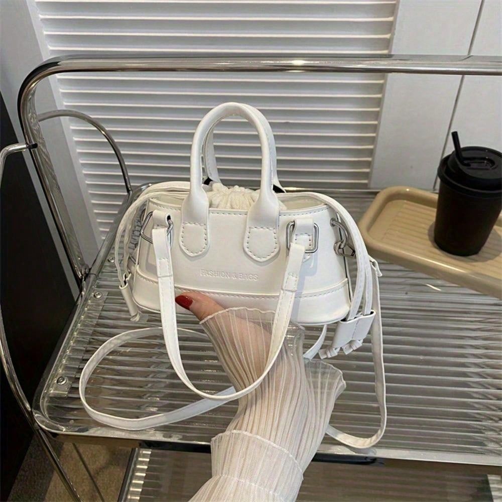 Elegant top handle clutch bag in white with detachable strap by LUNIVA CARE USA held by hand