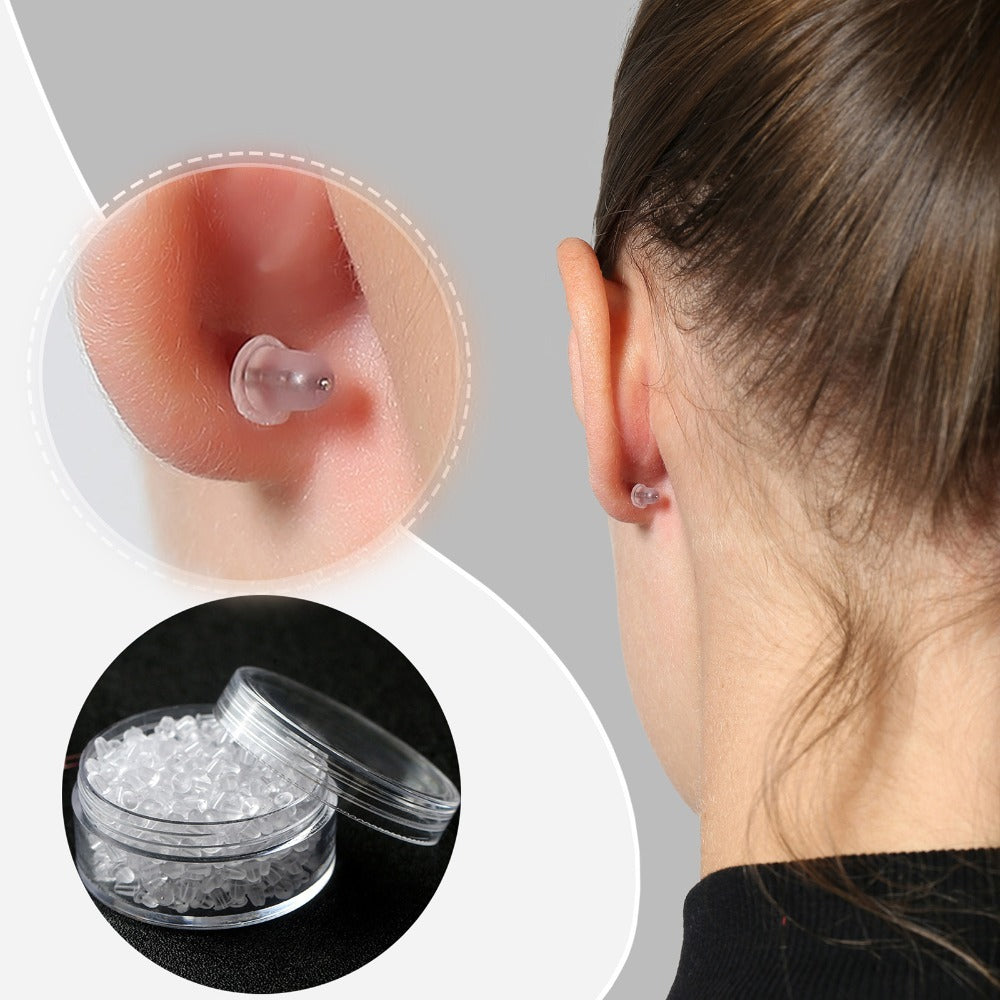 Clear silicone earring backs shown on ear and stored in a small transparent container by LUNIVA CARE USA