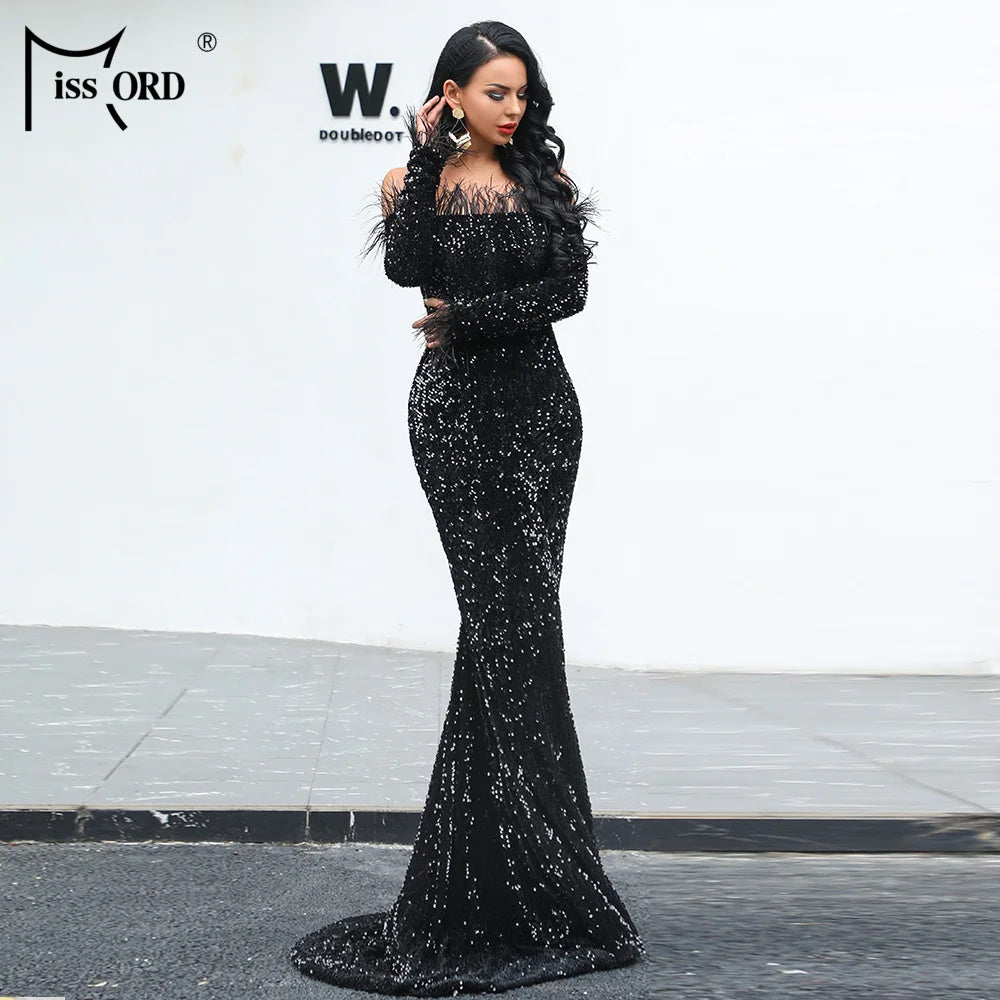 Woman wearing elegant black off shoulder sequin maxi dress with long sleeves and fitted silhouette