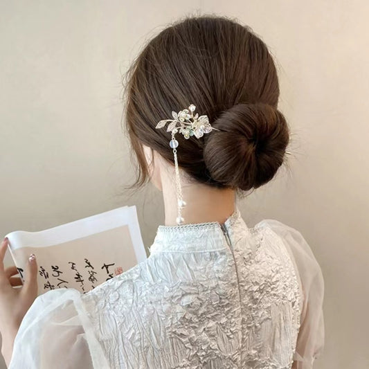 Luxury hair stick for special occasions securing an elegant floral hairpin on a sleek bun