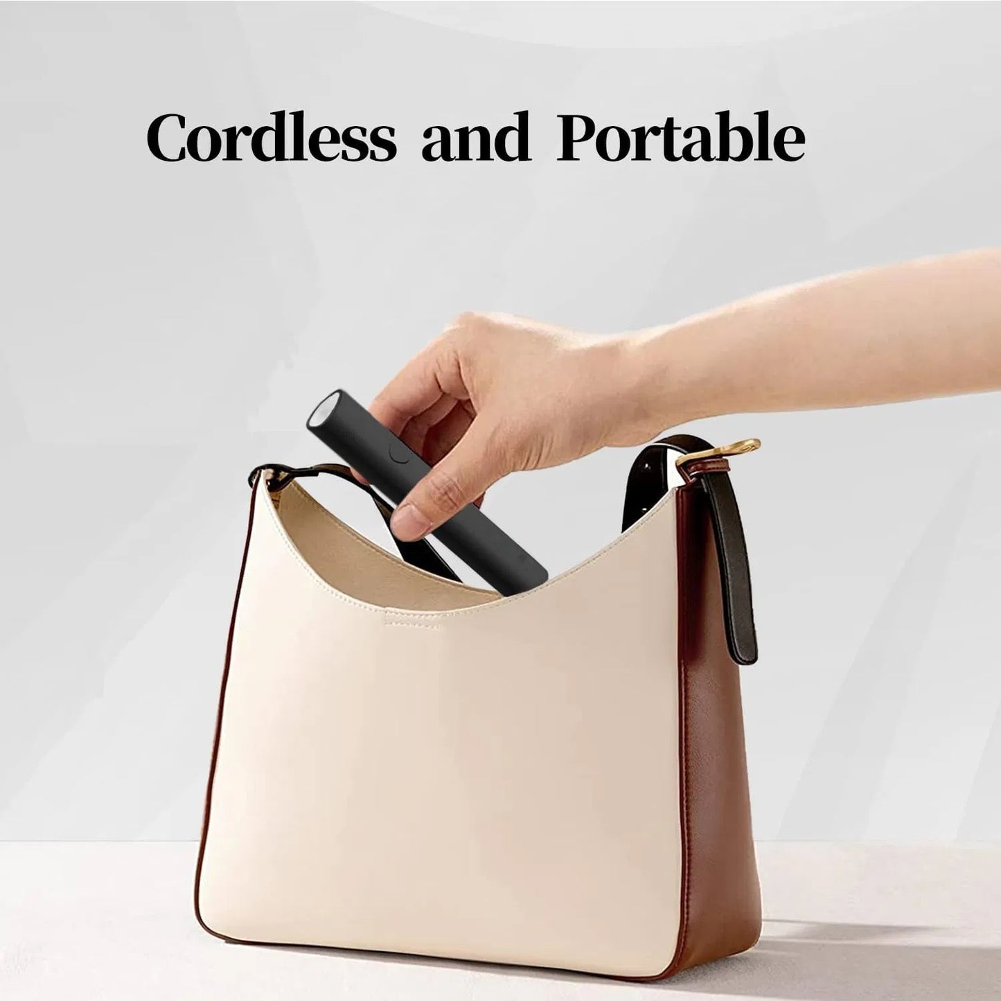 LUNIVA CARE USA mini UV LED nail lamp being placed into a beige and brown handbag showcasing its cordless and portable design