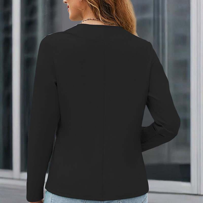 Back view of a woman wearing a black plus size blazer for women paired with light blue jeans