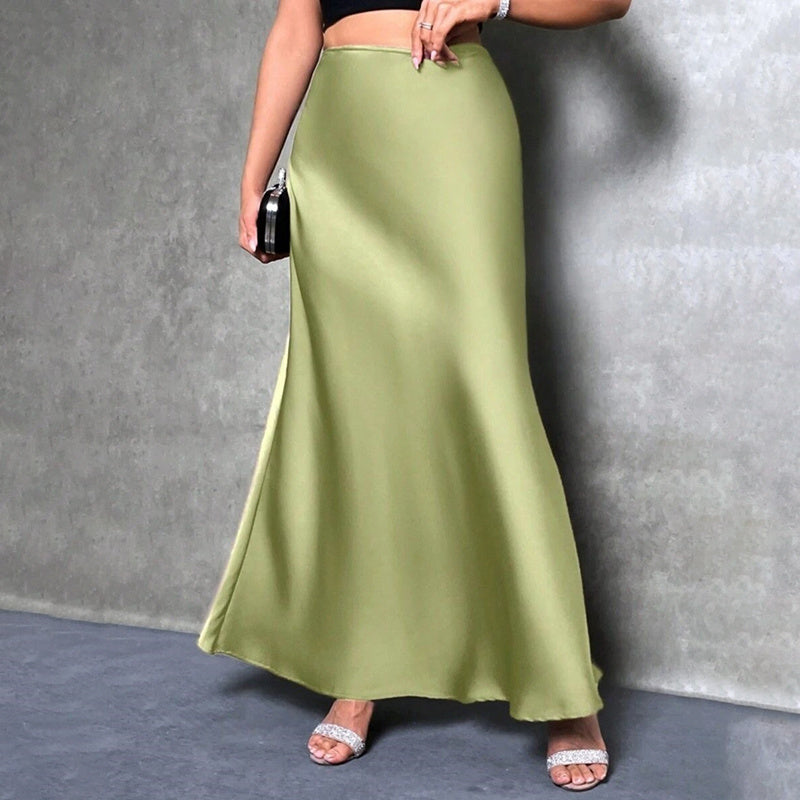 Woman wearing an elegant satin midi skirt in olive green with a smooth flowing design