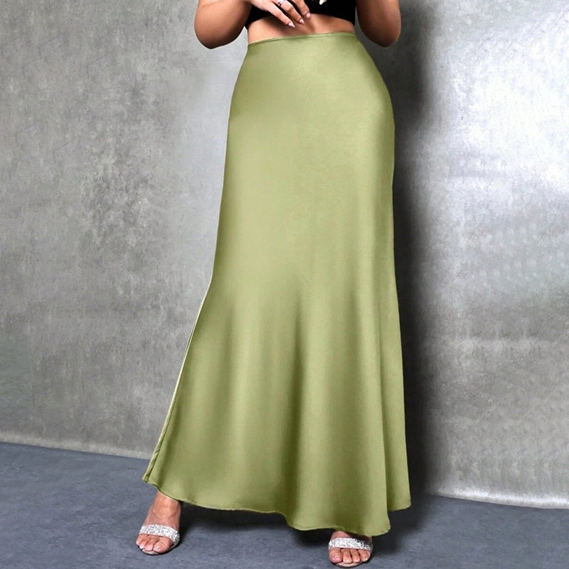 Woman wearing an elegant satin midi skirt in olive green with a smooth flow and high waist design