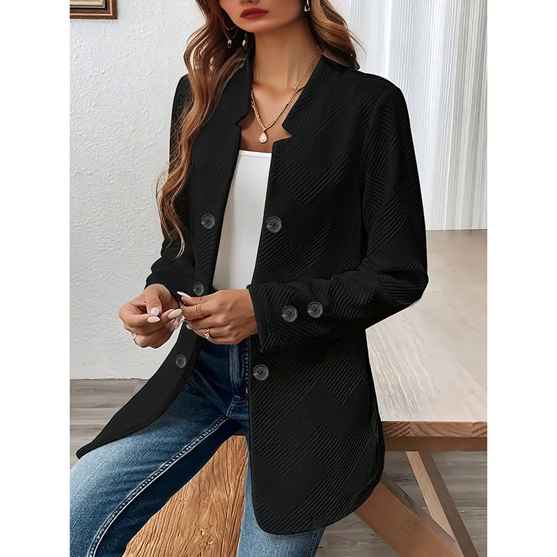 Black women's open front blazer jacket with button details worn over white top and blue jeans
