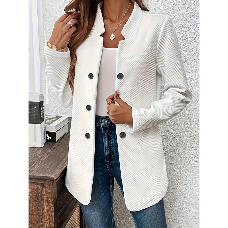 White women's open front blazer jacket with textured pattern worn with blue jeans and layered necklaces