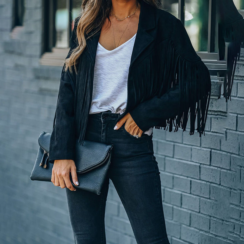 Woman wearing black women's faux suede fringe jacket with white shirt and black jeans holding black clutch