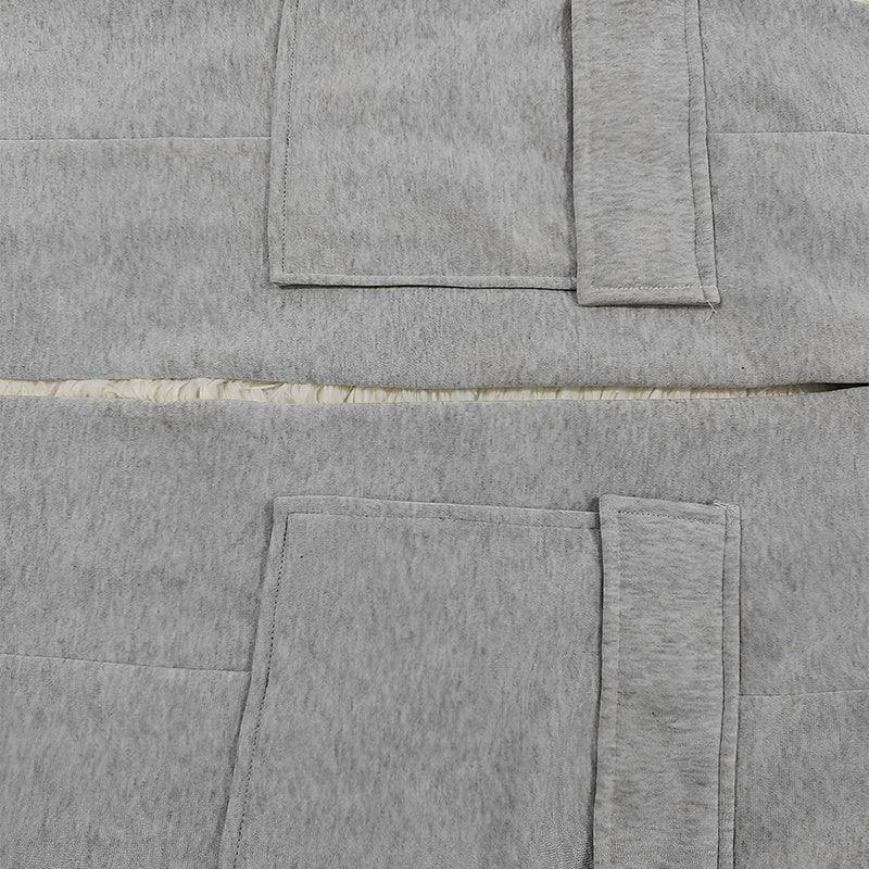 Close-up detail of gray fabric and stitching on women's straight leg pants showing pockets and waistband