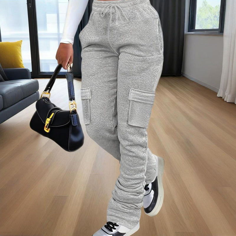 Gray casual women's straight leg pants with cargo pockets styled with white sneakers and black handbag