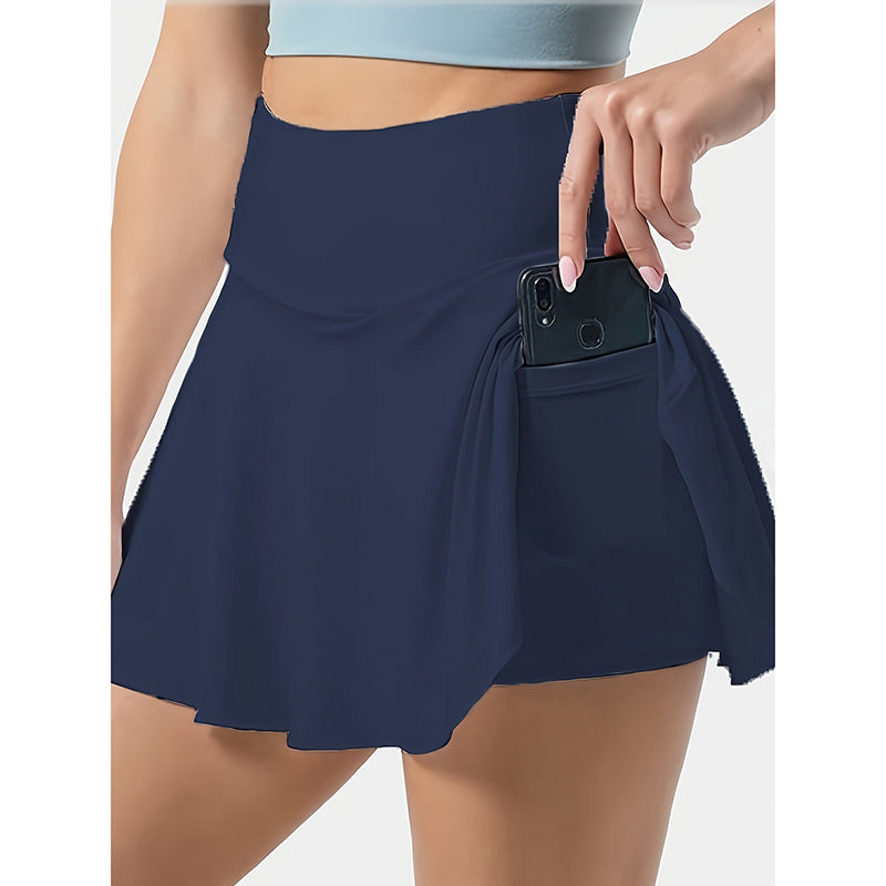 Navy blue women's tennis skirt with pockets holding a smartphone on a model