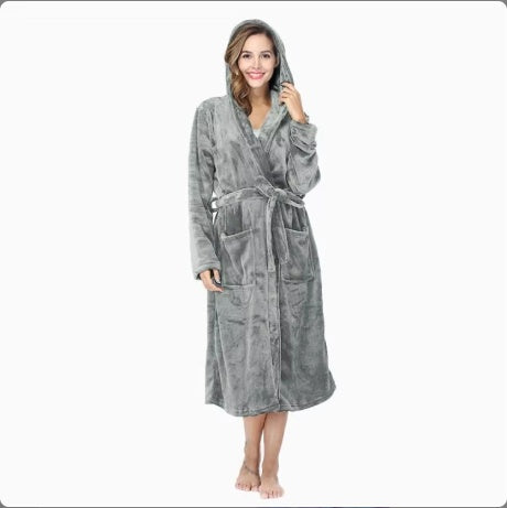 Woman wearing a soft gray women's winter flannel bathrobe with hood and belt standing barefoot