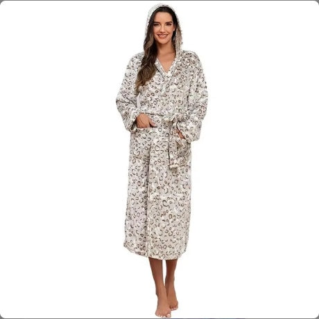 Woman wearing cozy women's winter flannel bathrobe with hood and leopard print pattern