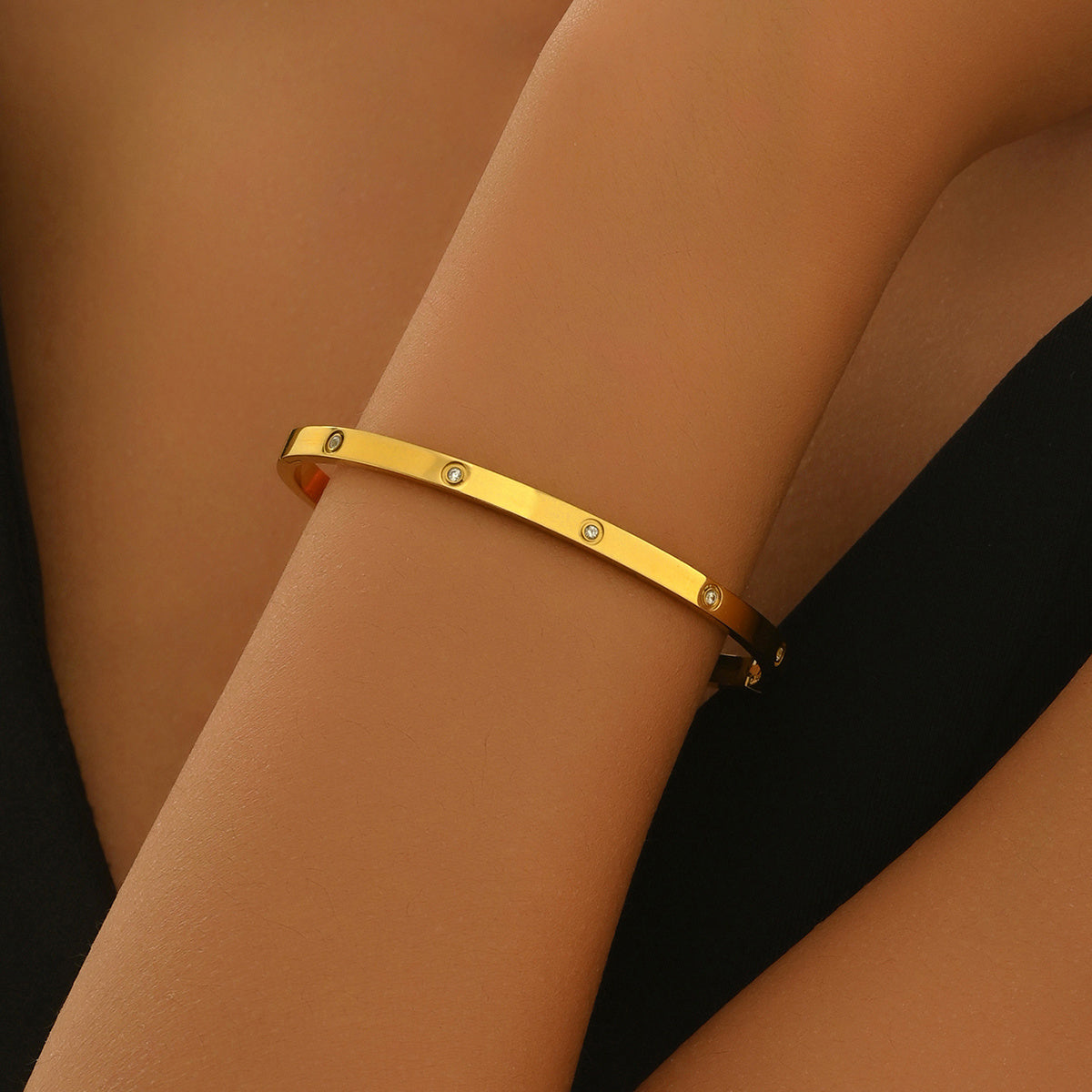 Minimalist 18K gold plated bracelet for women with small embedded stones on wrist