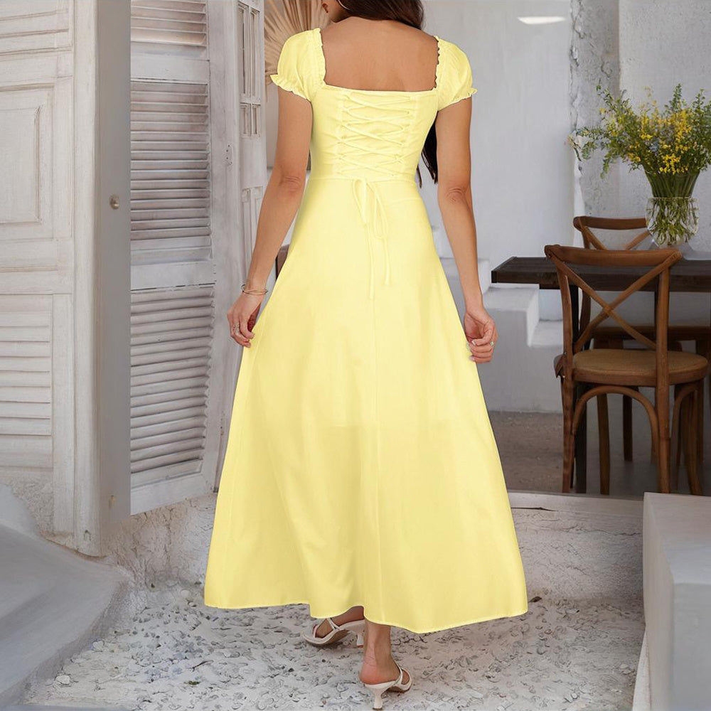 Woman wearing yellow bohemian backless maxi dress with puff sleeves and lace-up back design