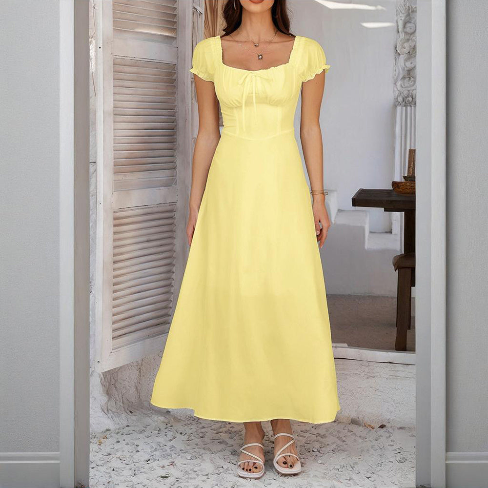 Woman wearing a yellow bohemian backless maxi dress with short sleeves and square neckline