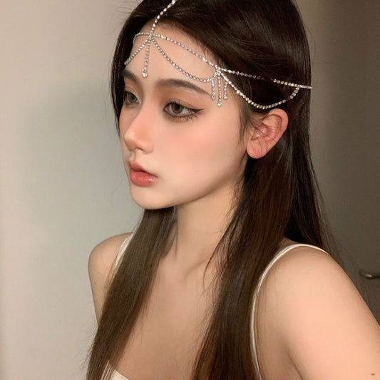 LUNIVA CARE USA bridal water diamond forehead chain worn on model with long brown hair and neutral makeup