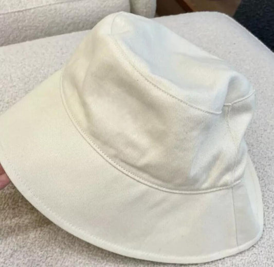 Cream colored cotton wide brim bucket hat with soft fabric and stitched brim edge