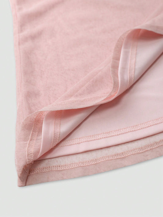 Close-up of soft pink fabric detail of an elegant wedding guest dress showing stitching and texture