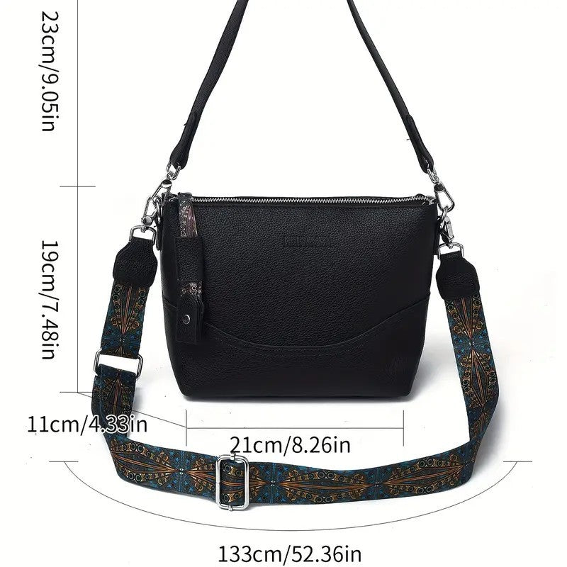 Black ethnic embroidery shoulder bag with adjustable patterned strap and zipper closure