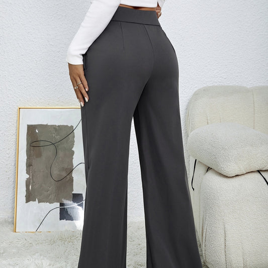Woman wearing black women's wide leg pants with a white long sleeve top in a modern living room