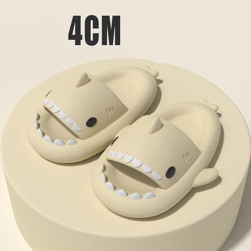 Beige funny shark slippers for adults with shark fin and teeth design on a beige pedestal