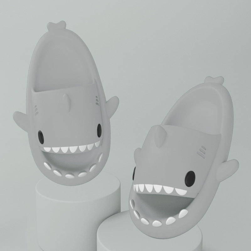Gray funny shark slippers for adults with open mouths and cartoon eyes in a playful design