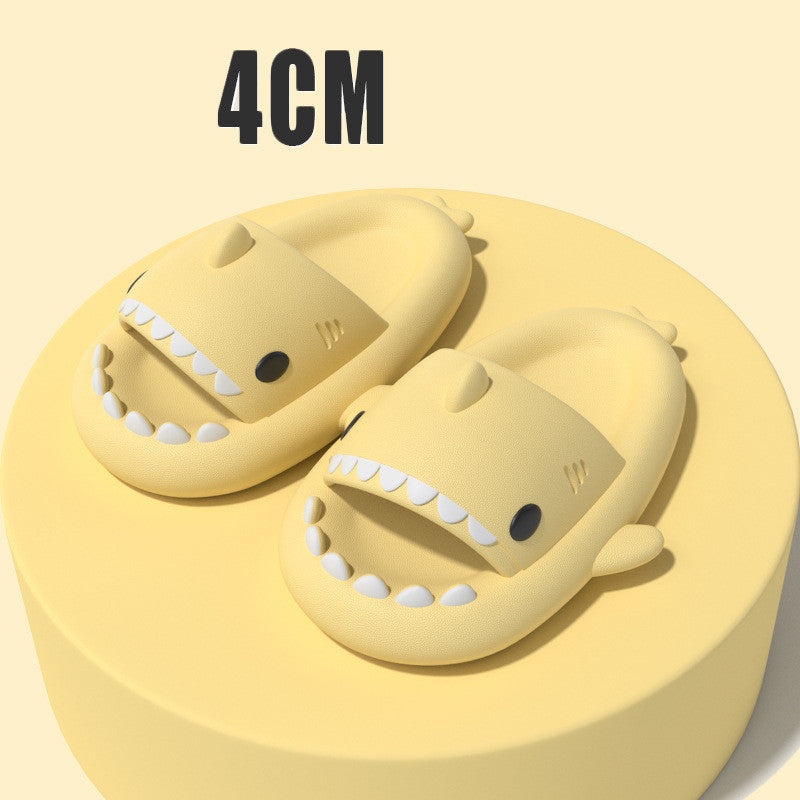 Yellow funny shark slippers for adults with open mouths and teeth design on a round platform