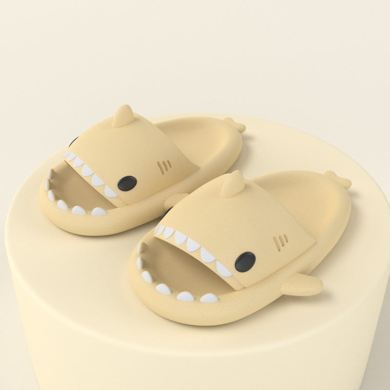 Beige funny shark slippers for adults with open mouths and teeth design on light background