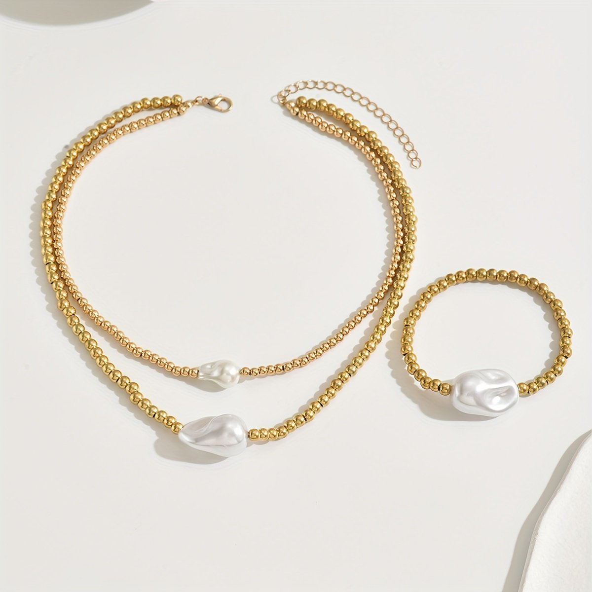 Handmade gold layered jewelry set with pearl accents including necklace and bracelet by LUNIVA CARE USA