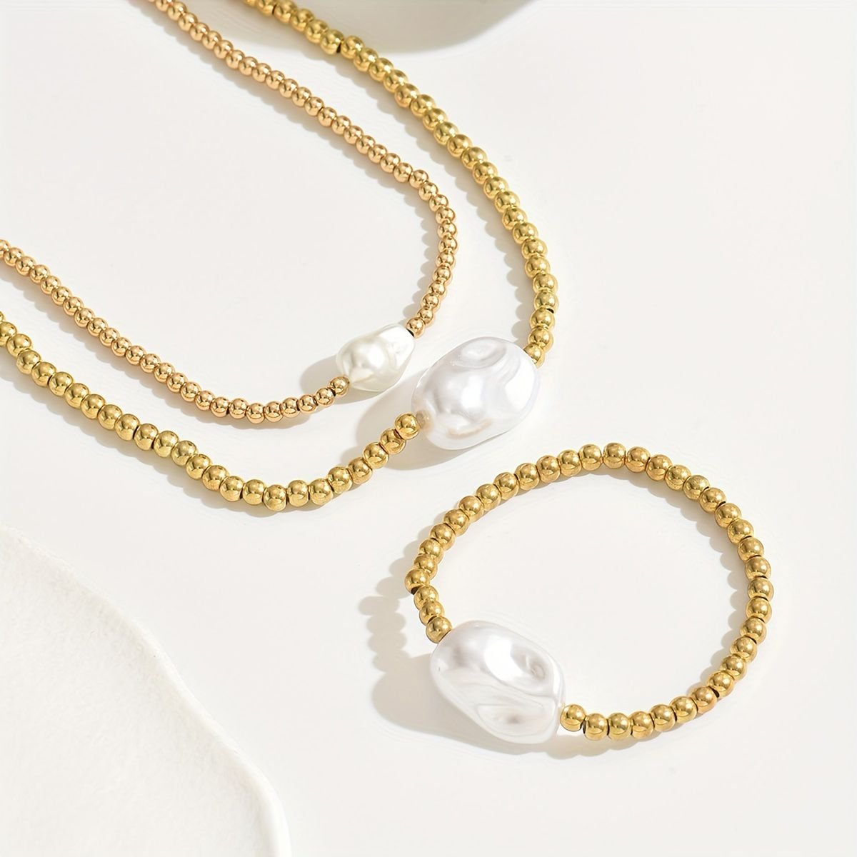 Handmade gold layered jewelry set with gold beads and white pearl accents by LUNIVA CARE USA