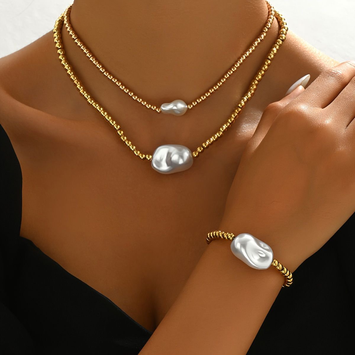 Handmade gold layered jewelry set with textured gold beads and irregular white pearl accents by LUNIVA CARE USA