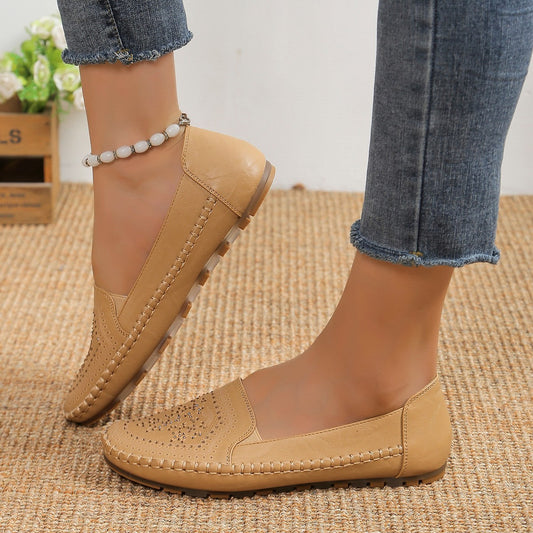 Beige handmade women's casual shoes with detailed stitching and soft sole paired with ankle bracelet