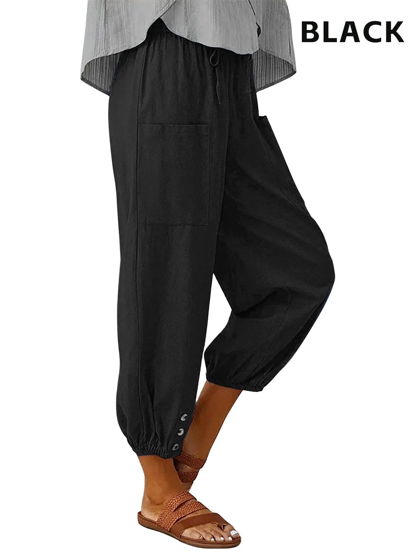 Black high waisted wide leg cropped pants with elastic cuffs worn with sandals