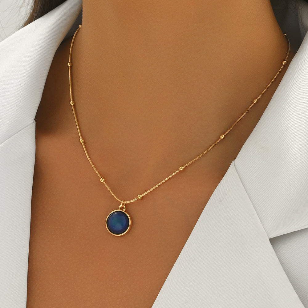 LUNIVA CARE USA luxury self-care necklace women with gold beaded chain and blue pendant on model