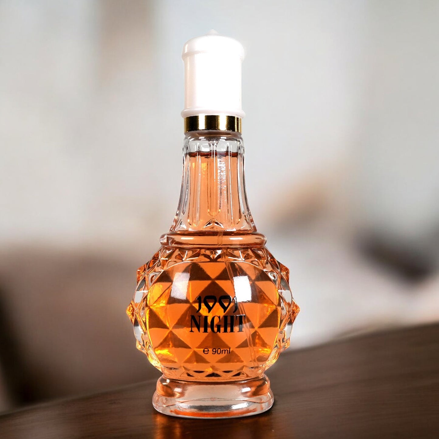 Luxury self-care perfume for women in a faceted glass bottle with amber liquid and white cap