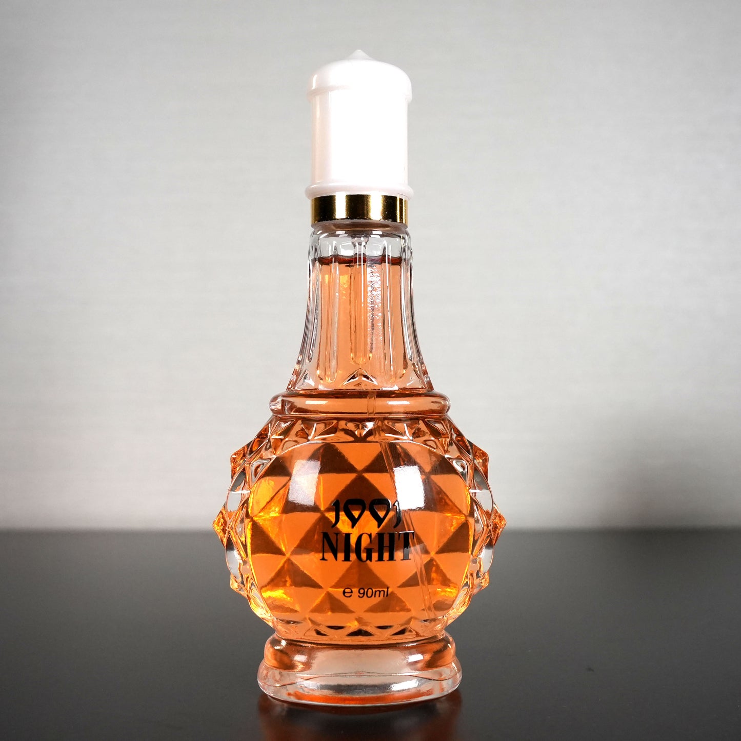 Luxury self-care perfume for women in a decorative faceted glass bottle with amber liquid