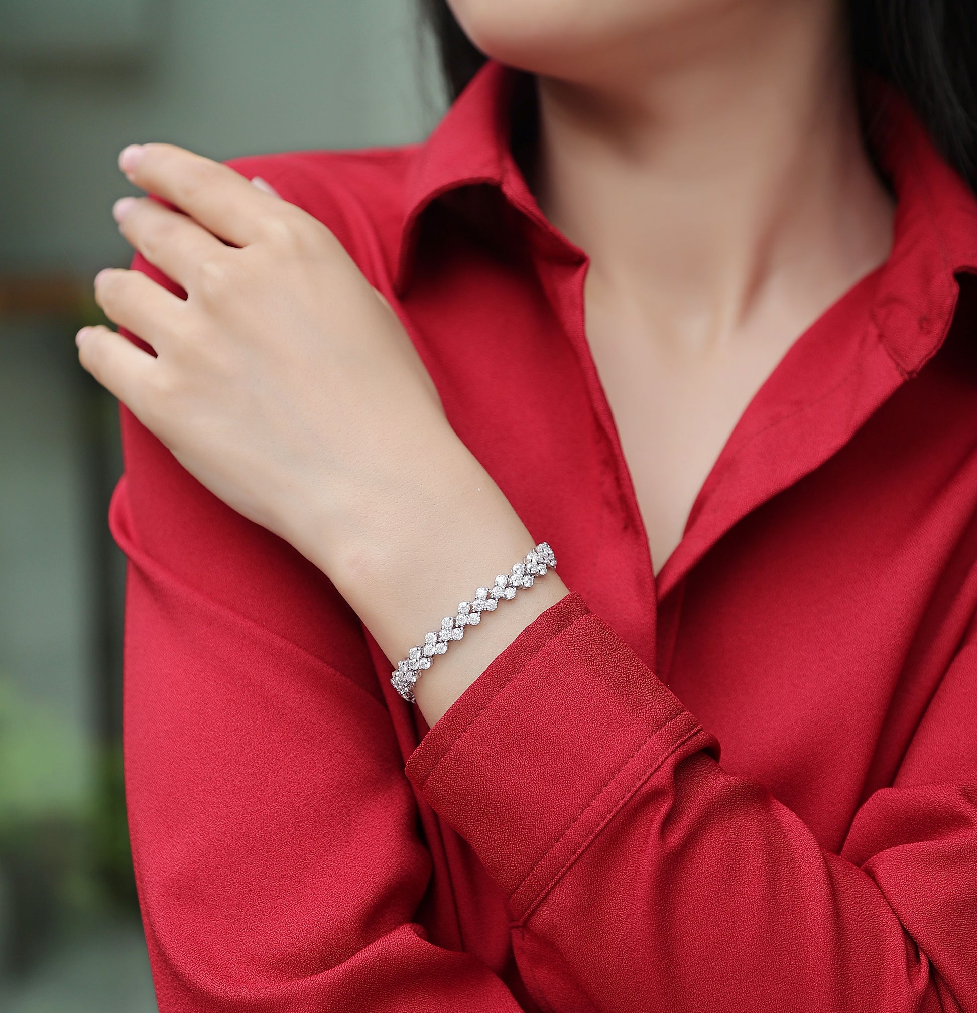 Elegant S925 silver moissanite bracelet worn on wrist with red long sleeve shirt by LUNIVA CARE USA