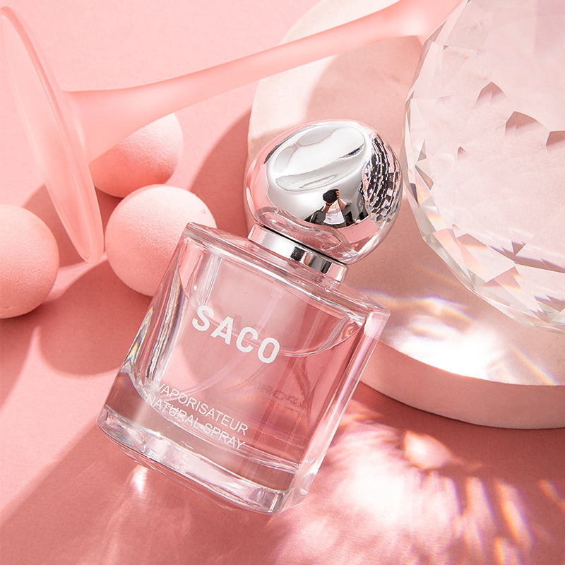 LUNIVA CARE USA SACO luxury self-care perfume bottle with pink liquid and silver cap on pink background