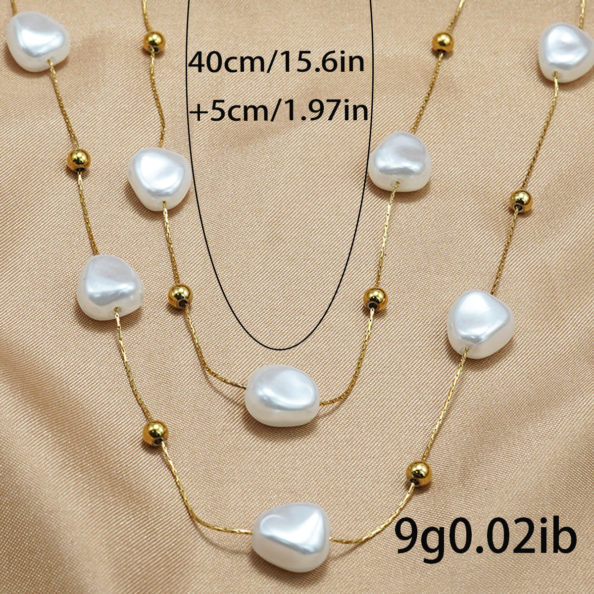 LUNIVA CARE USA 18K gold plated pearl necklace with irregular pearls and gold beads on a satin background