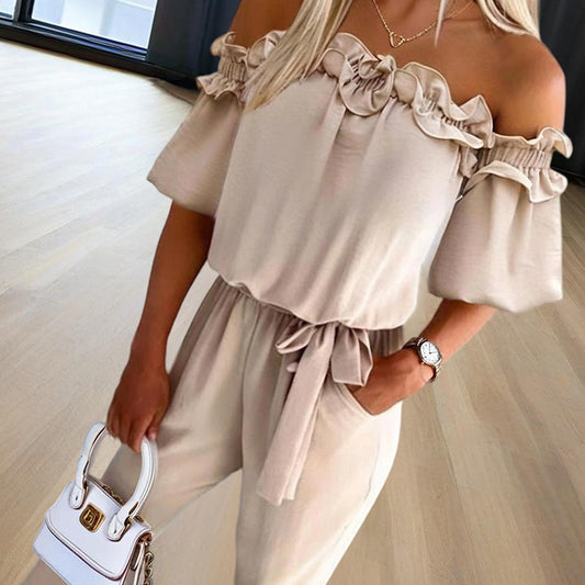 Woman wearing elegant off-shoulder jumpsuit for women in beige with ruffle detail and tie waist