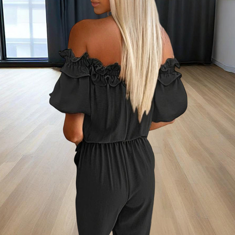 Back view of woman wearing an elegant off-shoulder jumpsuit for women in black with ruffle details