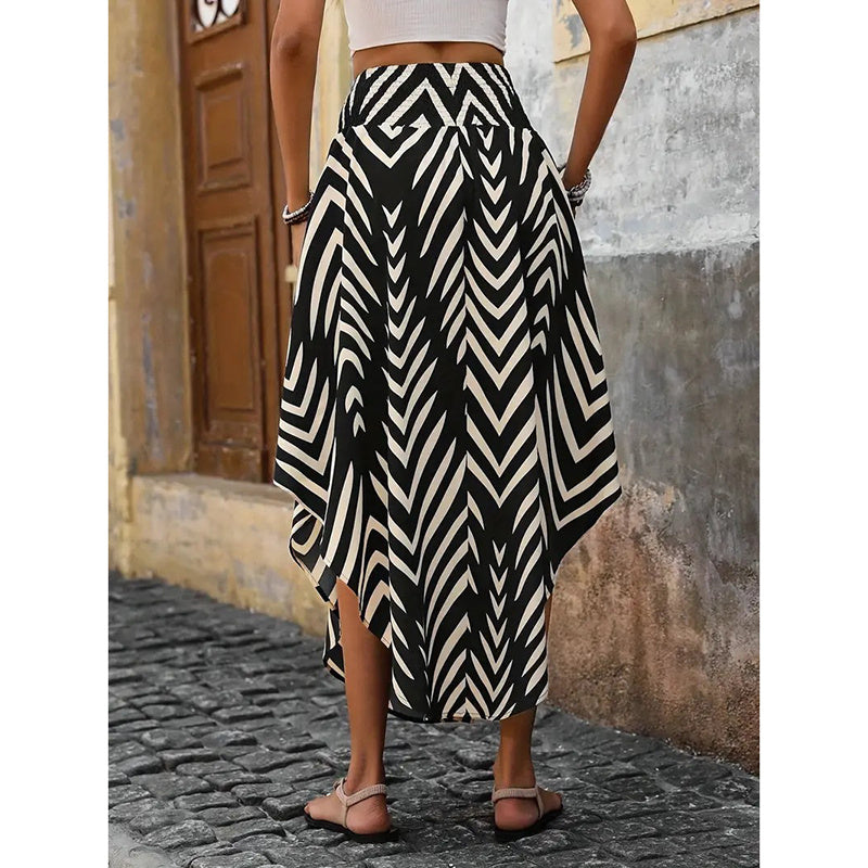 Woman wearing a black and white geometric patterned high waist floral midi skirt standing on cobblestone street