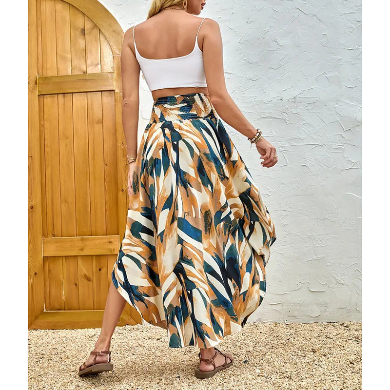 Woman wearing a high waist floral midi skirt with abstract leaf patterns and a white crop top