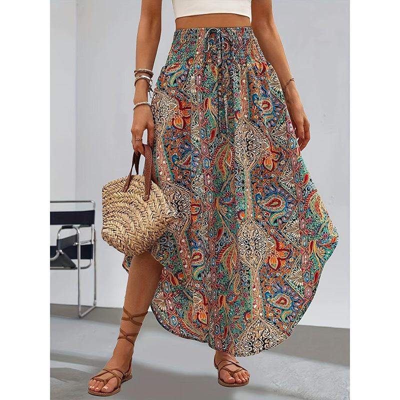 Woman wearing a high waist floral midi skirt with colorful paisley patterns and holding a woven handbag