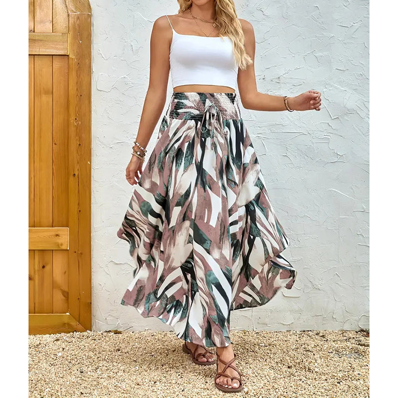 Woman wearing a high waist floral midi skirt with abstract leaf patterns and a white cropped tank top