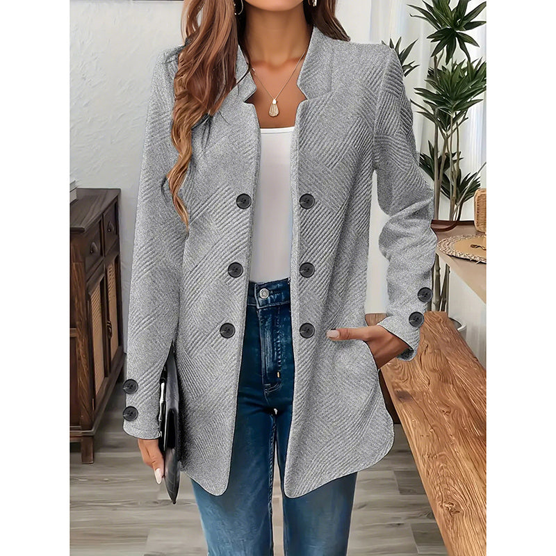 Gray women's open front blazer jacket with button details worn with white top and blue jeans