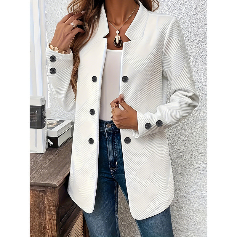 White women's open front blazer jacket with black buttons styled with blue jeans and gold jewelry