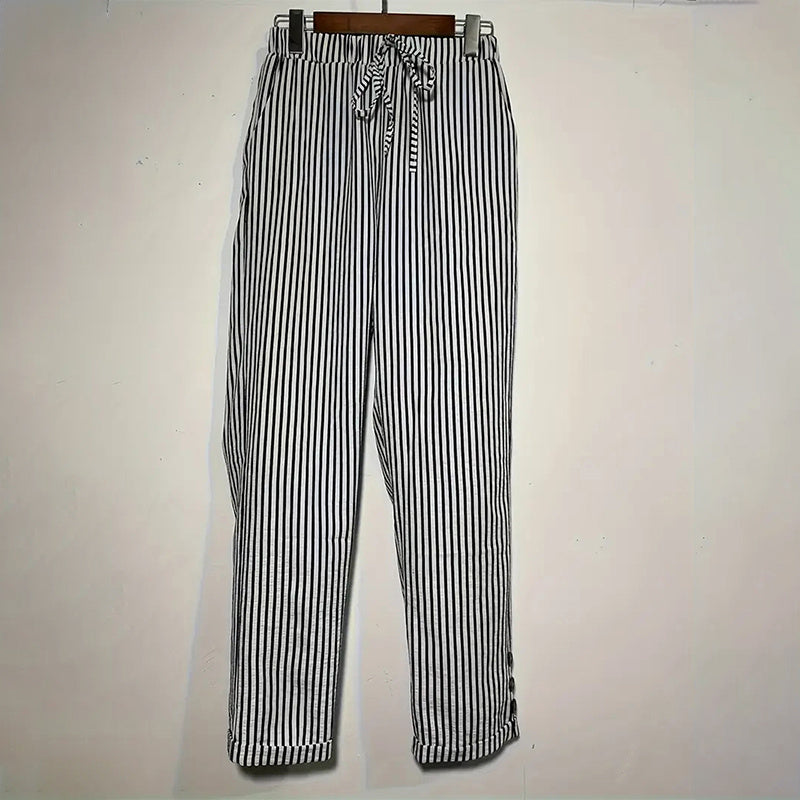 Women's striped elastic waist pants in black and white with drawstring and tapered legs